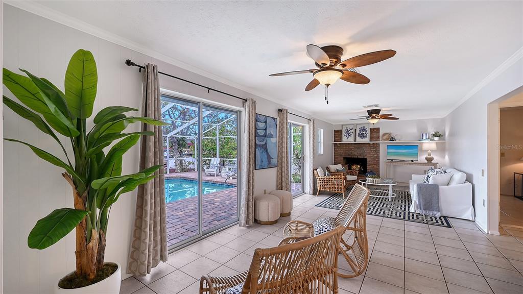 619 Albee Farm Road North Nokomis, FL 34275 - Photo 24 of 93 a living room with furniture a potted plant and a chandelier