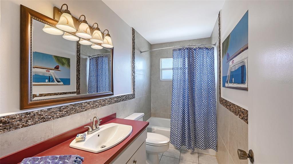 619 Albee Farm Road North Nokomis, FL 34275 - Photo 48 of 93 a bathroom with a sink a toilet and mirror