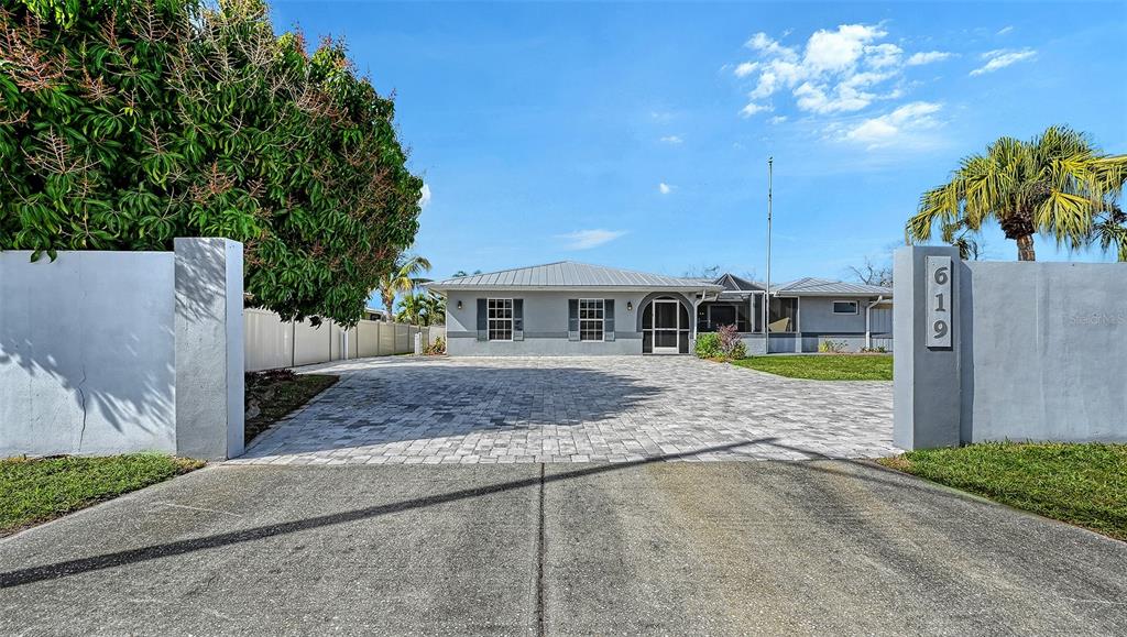 619 Albee Farm Road North Nokomis, FL 34275 - Photo 6 of 93 a front view of a house with a yard and garage