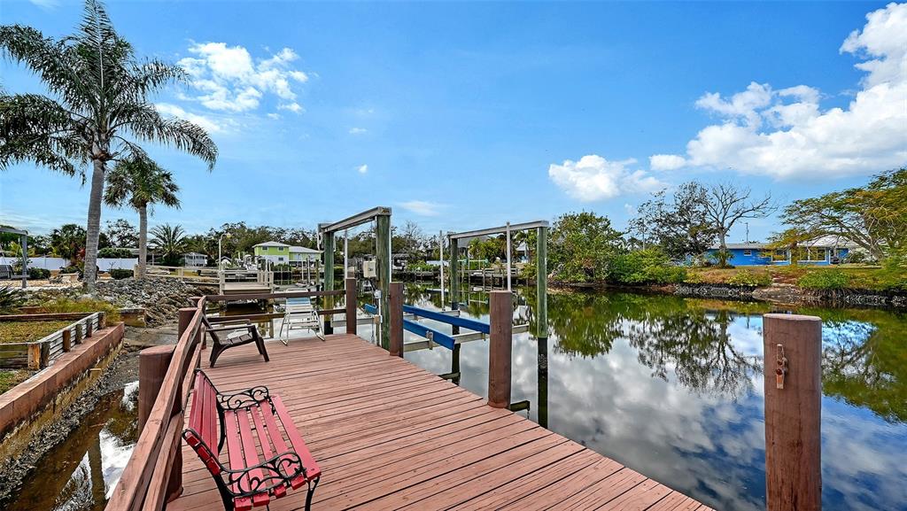 619 Albee Farm Road North Nokomis, FL 34275 - Photo 67 of 93 a view of a lake with a table and chairs