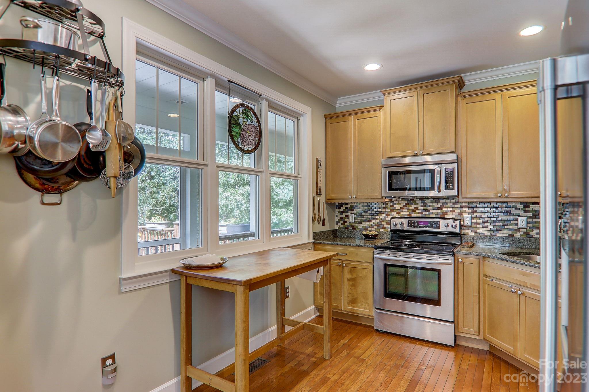 209 Whitaker Road Fairview, NC 28730 - Photo 14 of 44 a kitchen with stainless steel appliances granite countertop a stove and a sink