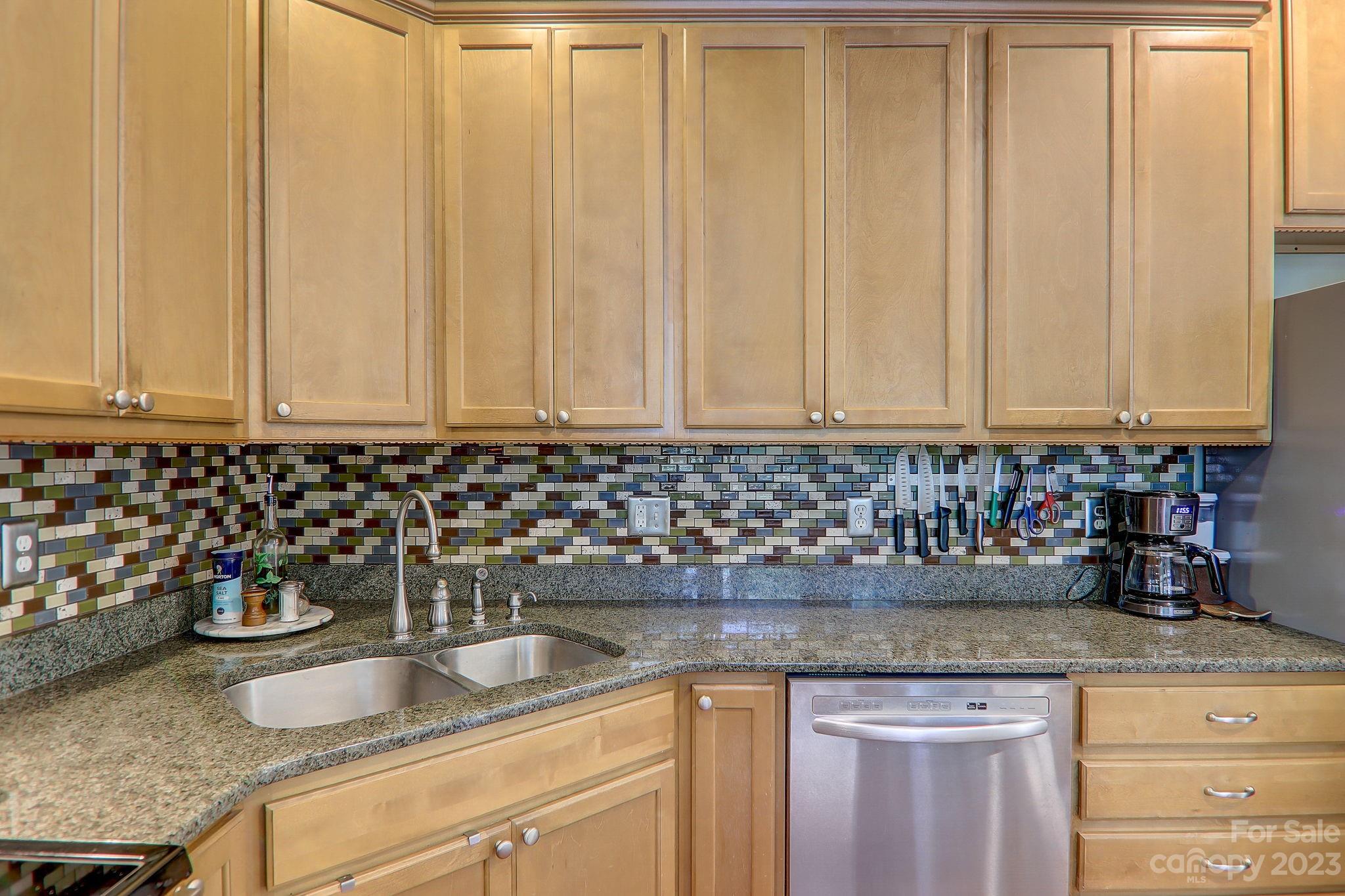 209 Whitaker Road Fairview, NC 28730 - Photo 15 of 44 a kitchen with granite countertop white cabinets and a sink