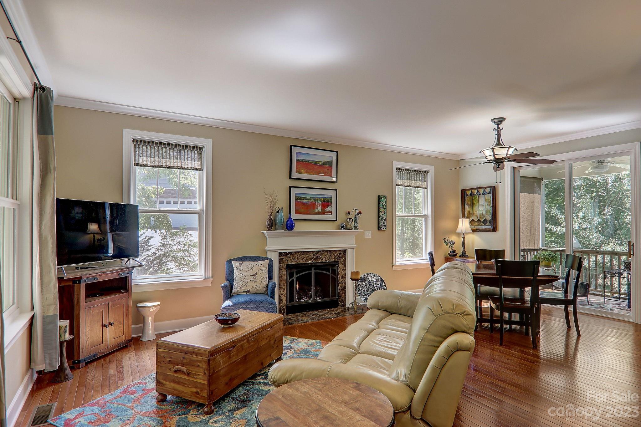 209 Whitaker Road Fairview, NC 28730 - Photo 17 of 44 a living room with furniture a flat screen tv and a fireplace