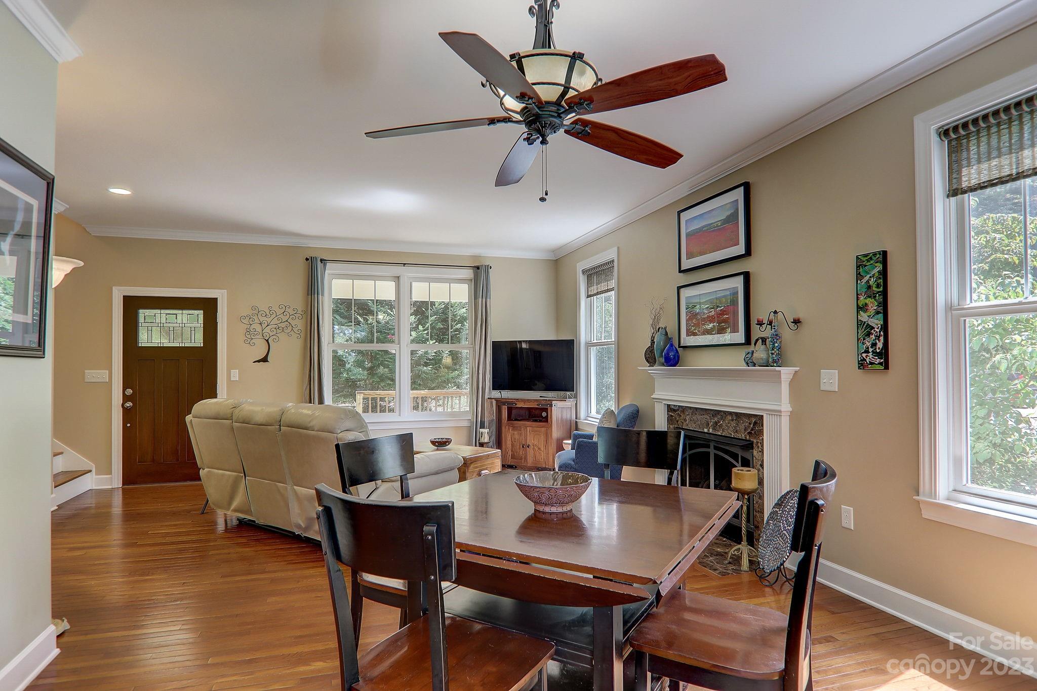 209 Whitaker Road Fairview, NC 28730 - Photo 18 of 44 a living room with furniture a fireplace and a flat screen tv
