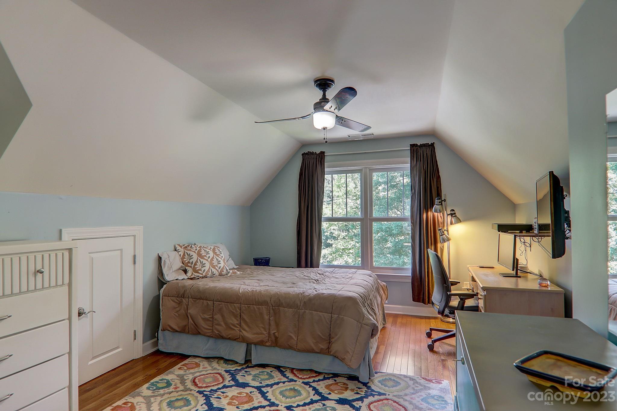 209 Whitaker Road Fairview, NC 28730 - Photo 22 of 44 a bedroom with a bed a chandelier and a window