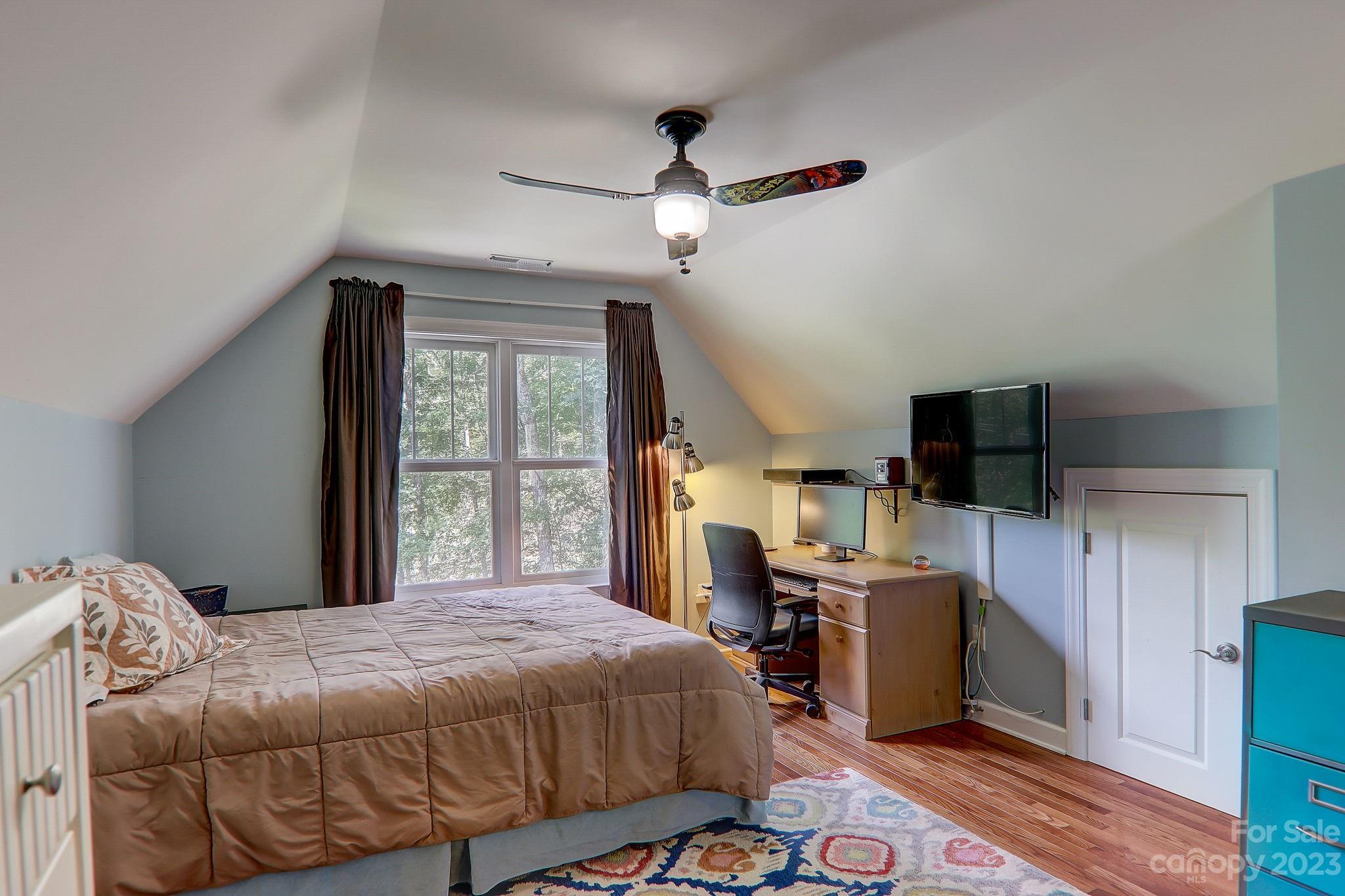 209 Whitaker Road Fairview, NC 28730 - Photo 25 of 44 a bedroom with a bed and a flat screen tv