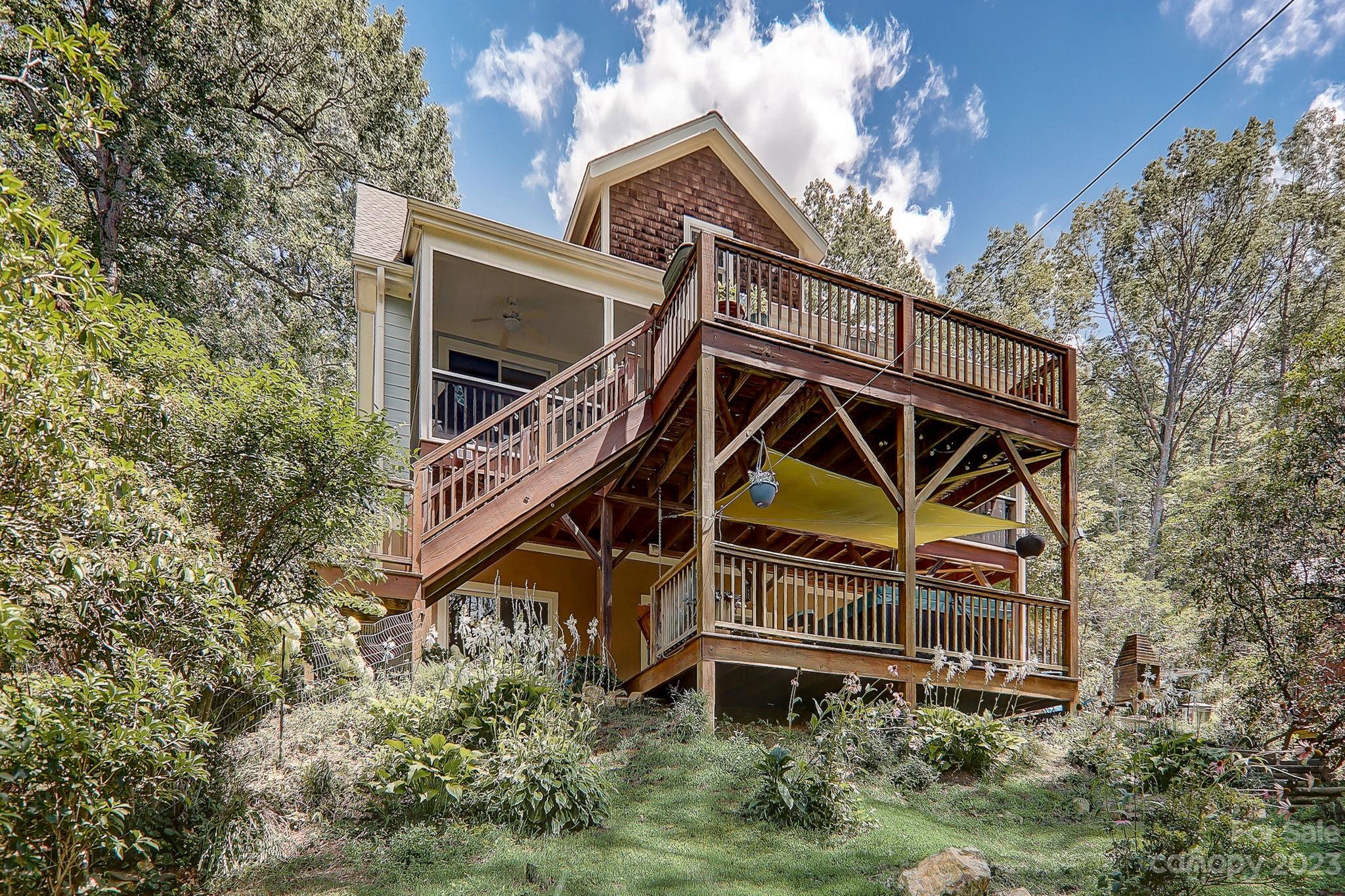 209 Whitaker Road Fairview, NC 28730 - Photo 3 of 44 a view of a house with a yard