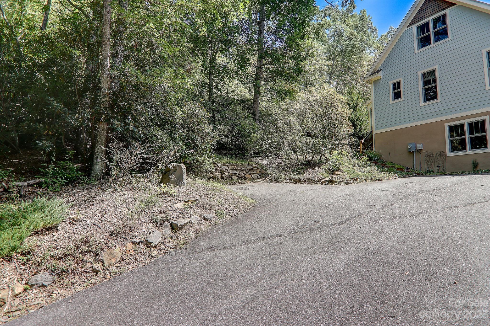 209 Whitaker Road Fairview, NC 28730 - Photo 34 of 44 a view of a house with a yard