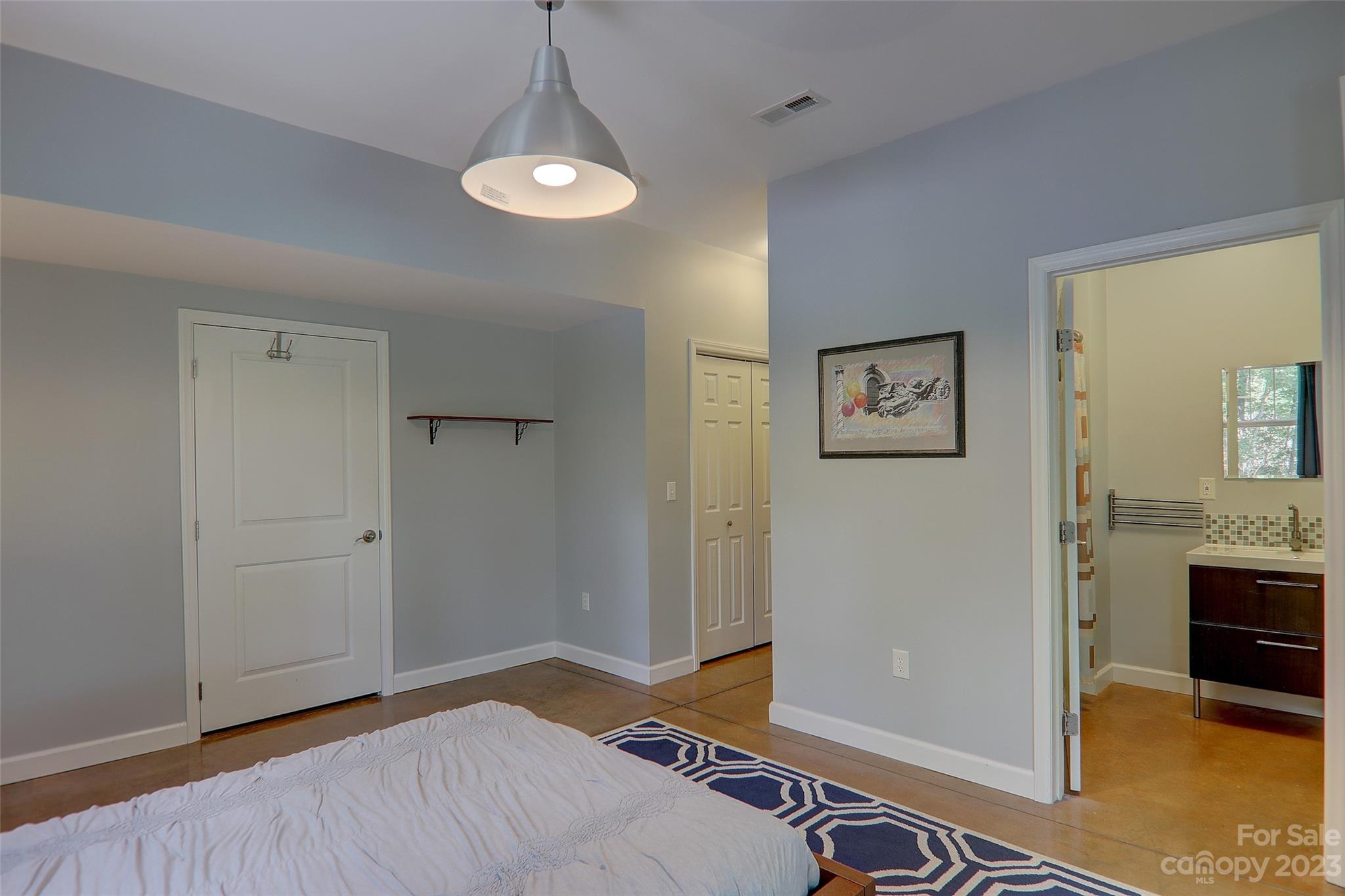 209 Whitaker Road Fairview, NC 28730 - Photo 39 of 44 a bedroom with a bed and a view of bathroom