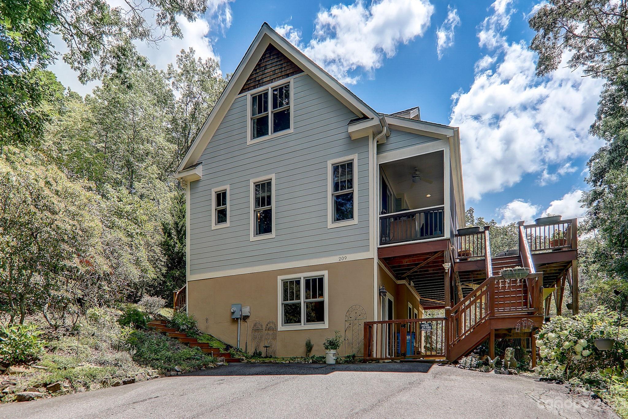 209 Whitaker Road Fairview, NC 28730 - Photo 8 of 44 a view of a house with a yard