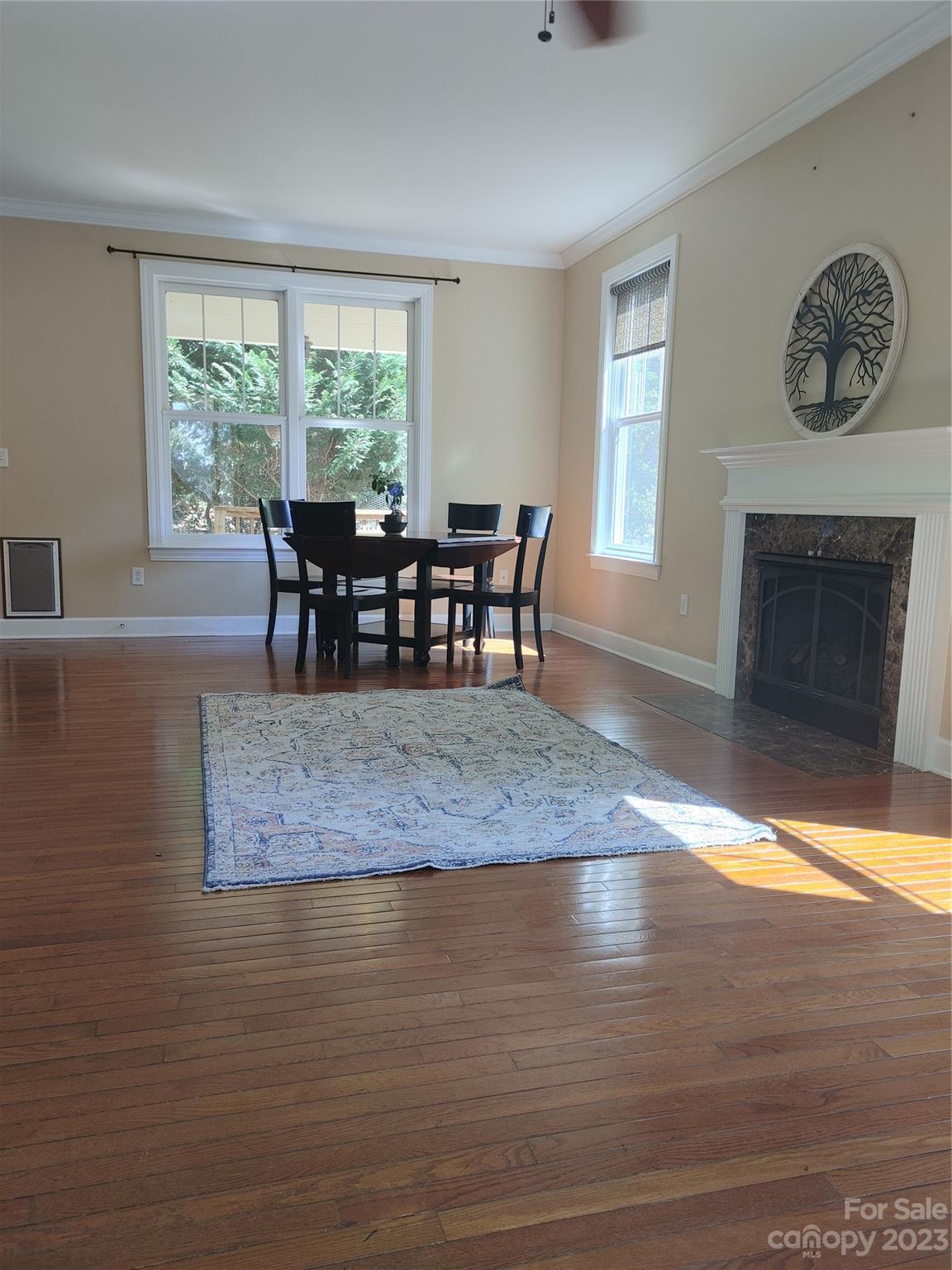 209 Whitaker Road Fairview, NC 28730 - Photo 10 of 44 a dining room with furniture window and wooden floor