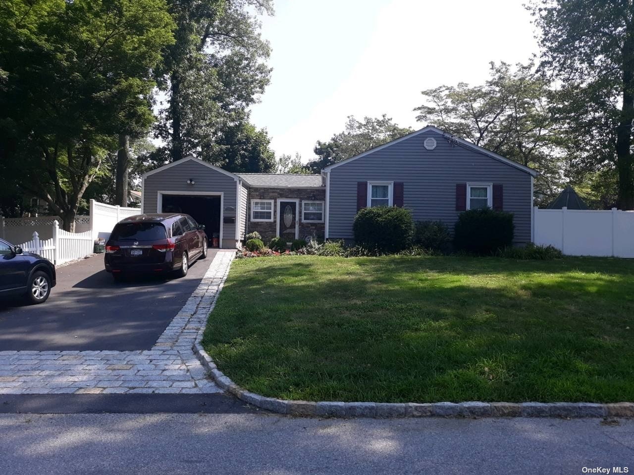256 Round Hill Drive Yonkers, NY 10710 - Photo 1 of 1 a front view of a house with a garden and trees