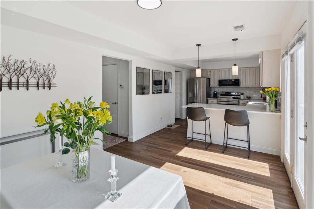 412 Chandler Place Pittsburgh, PA 15212 - Photo 17 of 38 a living room with furniture a chandelier and kitchen view