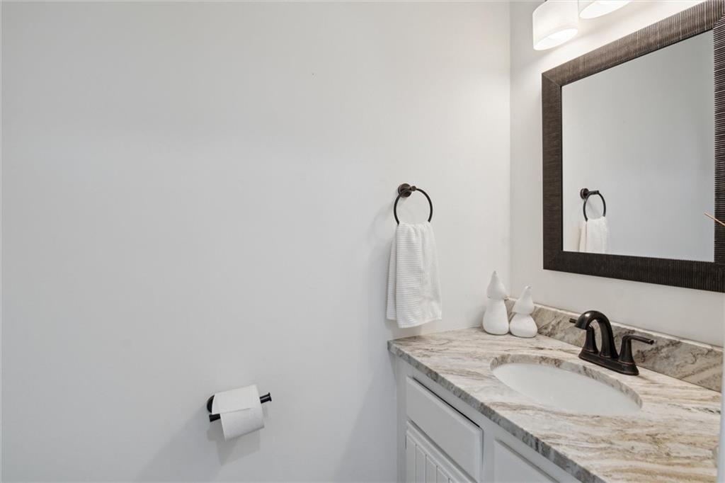 412 Chandler Place Pittsburgh, PA 15212 - Photo 18 of 38 a bathroom with a granite countertop sink and a mirror