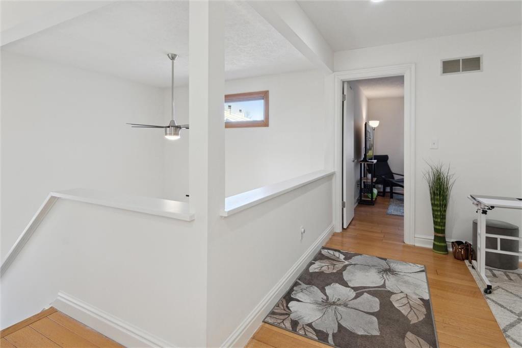 412 Chandler Place Pittsburgh, PA 15212 - Photo 22 of 38 a view of a hallway with wooden floor and living room