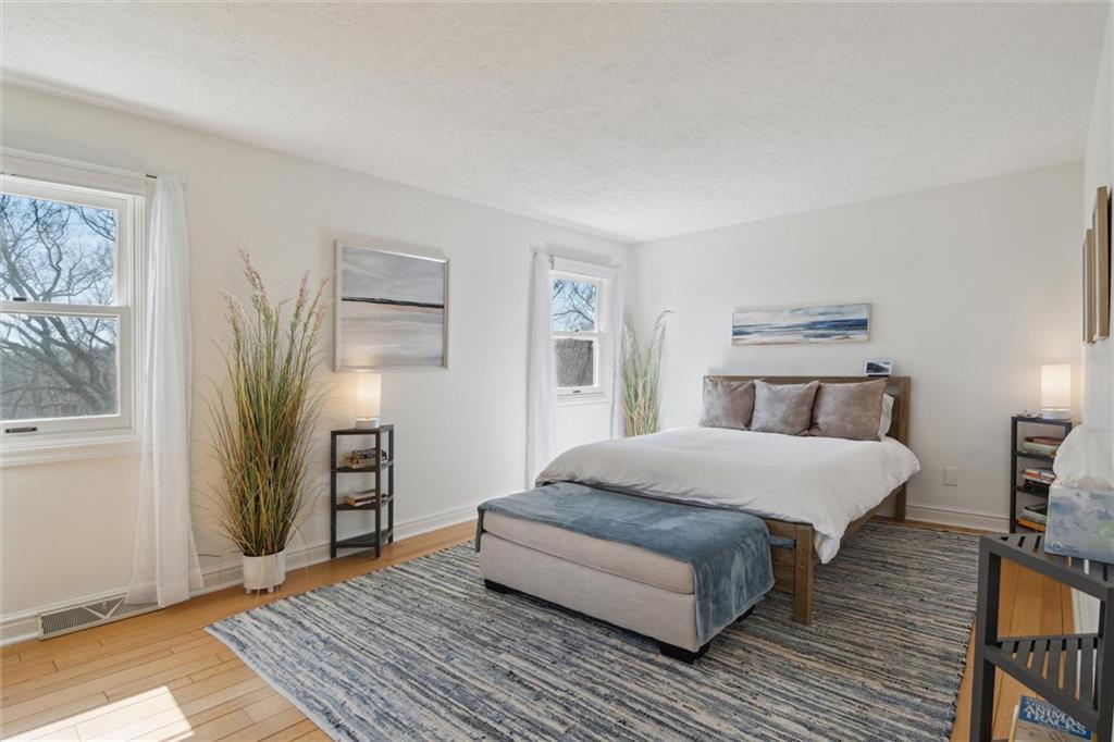 412 Chandler Place Pittsburgh, PA 15212 - Photo 26 of 38 a spacious bedroom with a bed and wooden floor