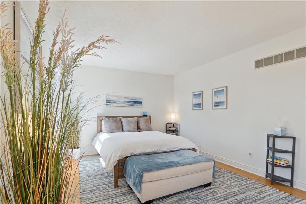 412 Chandler Place Pittsburgh, PA 15212 - Photo 27 of 38 a bedroom with a bed and wooden floor