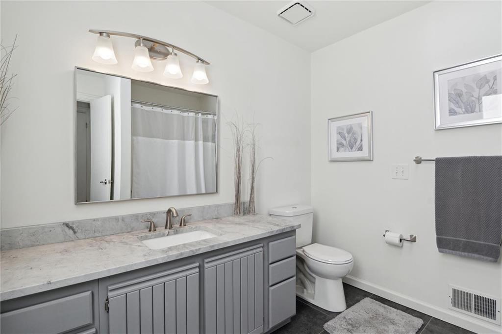412 Chandler Place Pittsburgh, PA 15212 - Photo 30 of 38 a bathroom with a granite countertop toilet sink and mirror