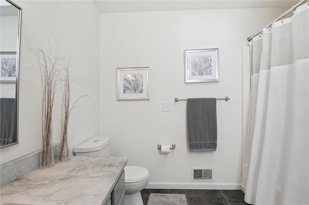 412 Chandler Place Pittsburgh, PA 15212 - Photo 31 of 38 a bathroom with a granite countertop toilet and a sink