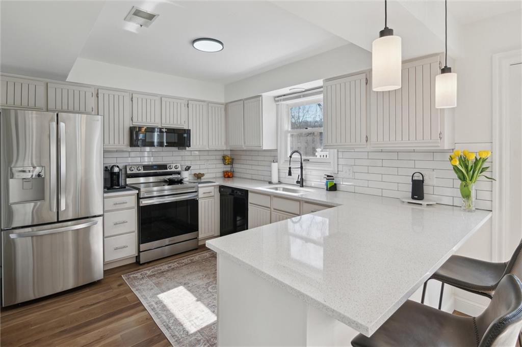 412 Chandler Place Pittsburgh, PA 15212 - Photo 10 of 38 a kitchen with kitchen island a sink stainless steel appliances and cabinets