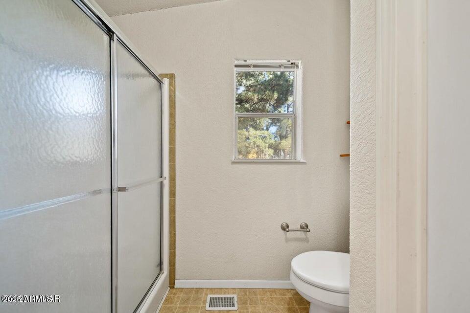 2421 West Thornton Road Show Low, AZ 85901 - Photo 36 of 48 a bathroom with a toilet and a shower