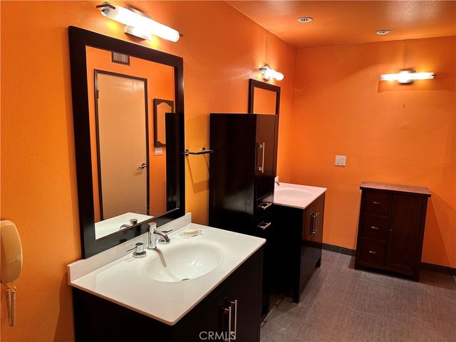 a bathroom with a sink vanity and a mirror
