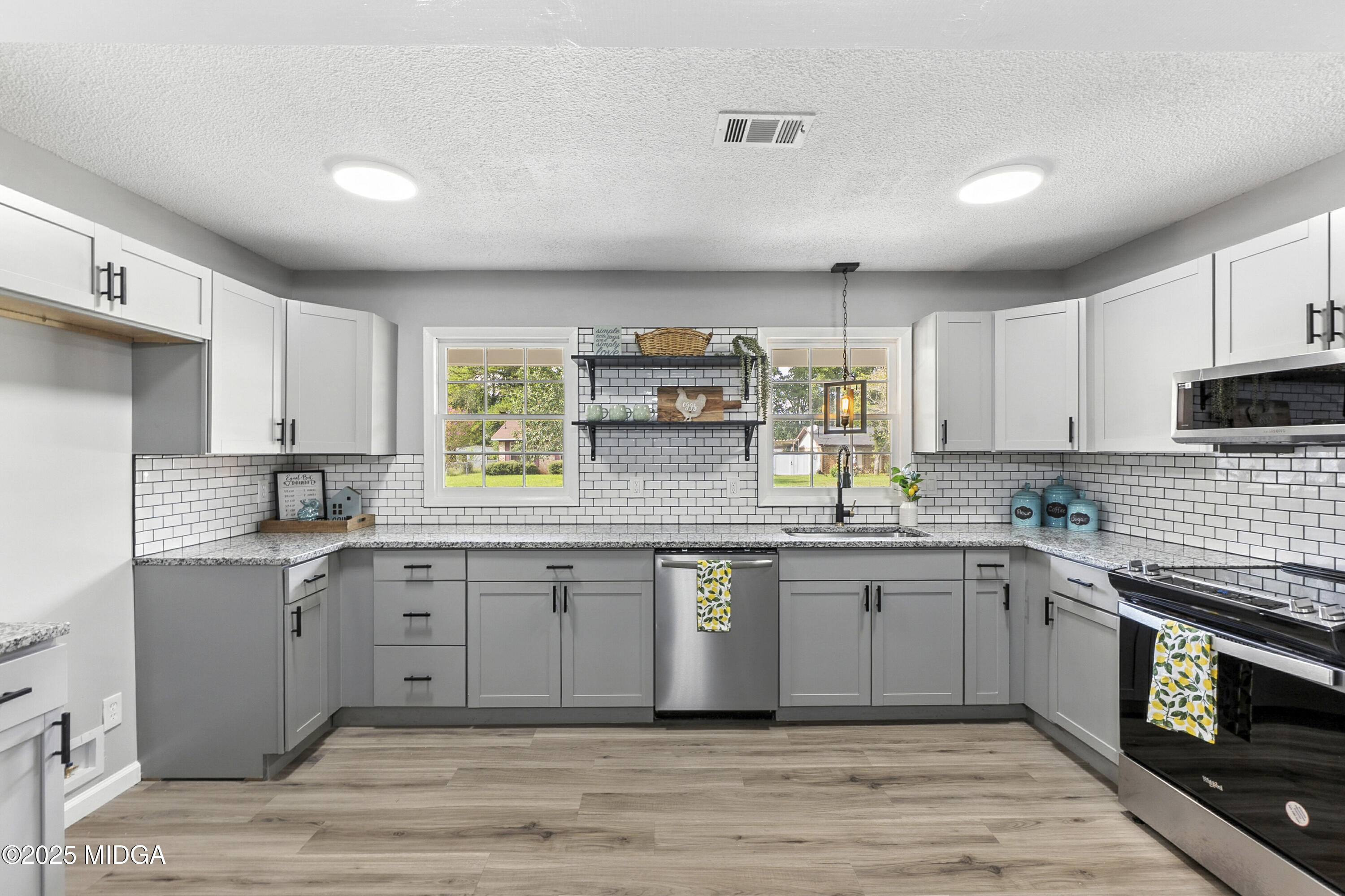 109 Scarborough Road Centerville, GA 31028 - Photo 12 of 52 a kitchen with stainless steel appliances granite countertop a stove sink and cabinets