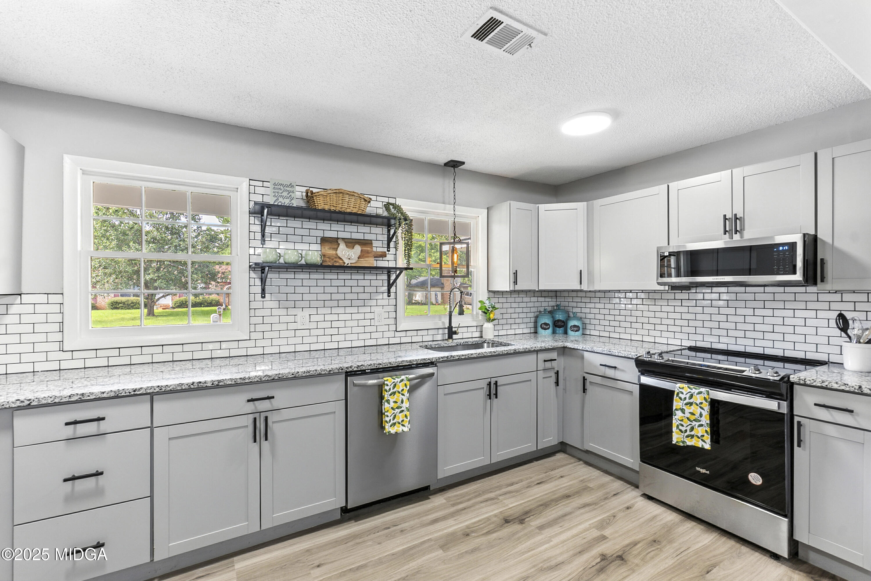 109 Scarborough Road Centerville, GA 31028 - Photo 13 of 52 a kitchen with stainless steel appliances granite countertop a stove sink and cabinets