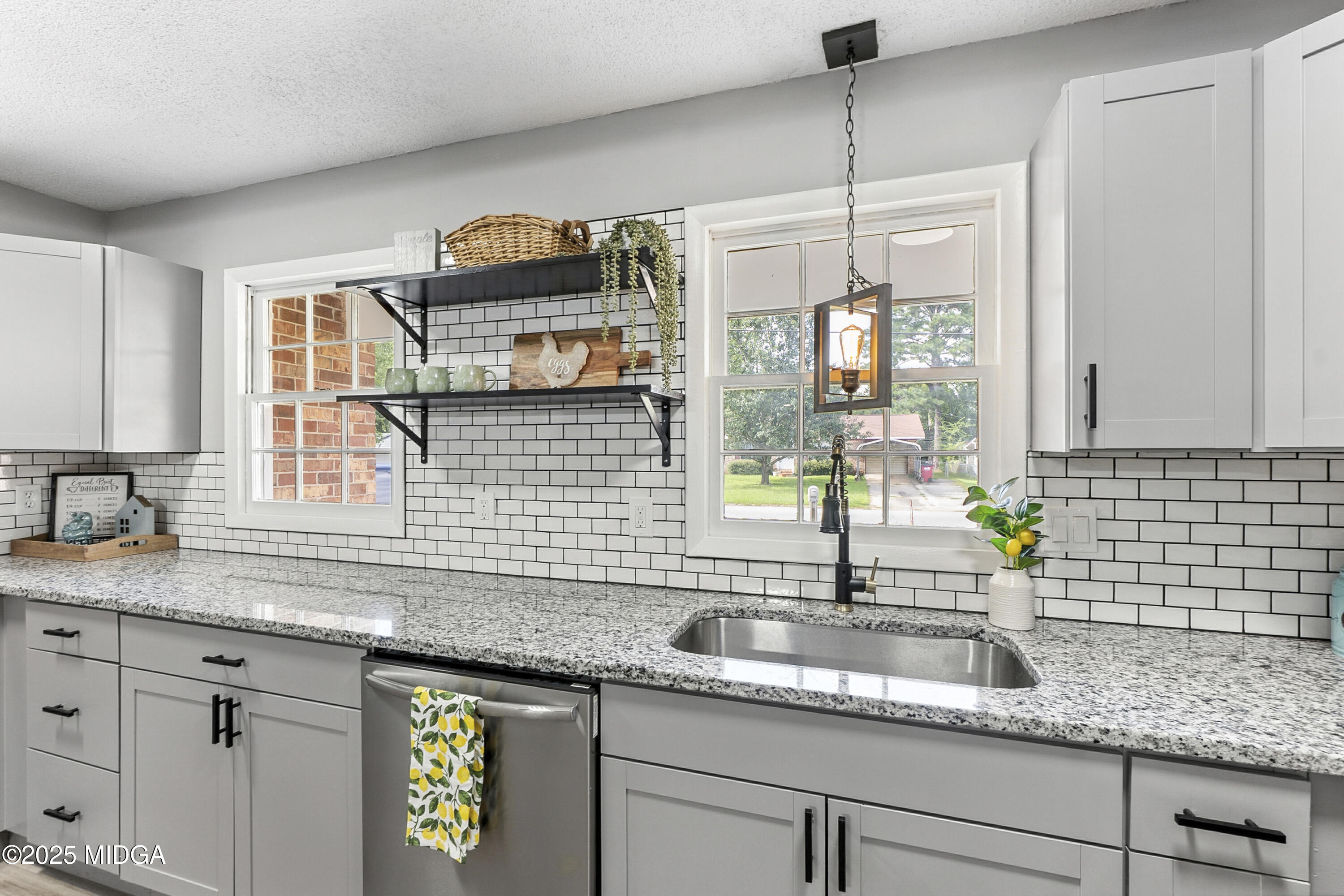 109 Scarborough Road Centerville, GA 31028 - Photo 15 of 52 a kitchen with sink cabinets and window