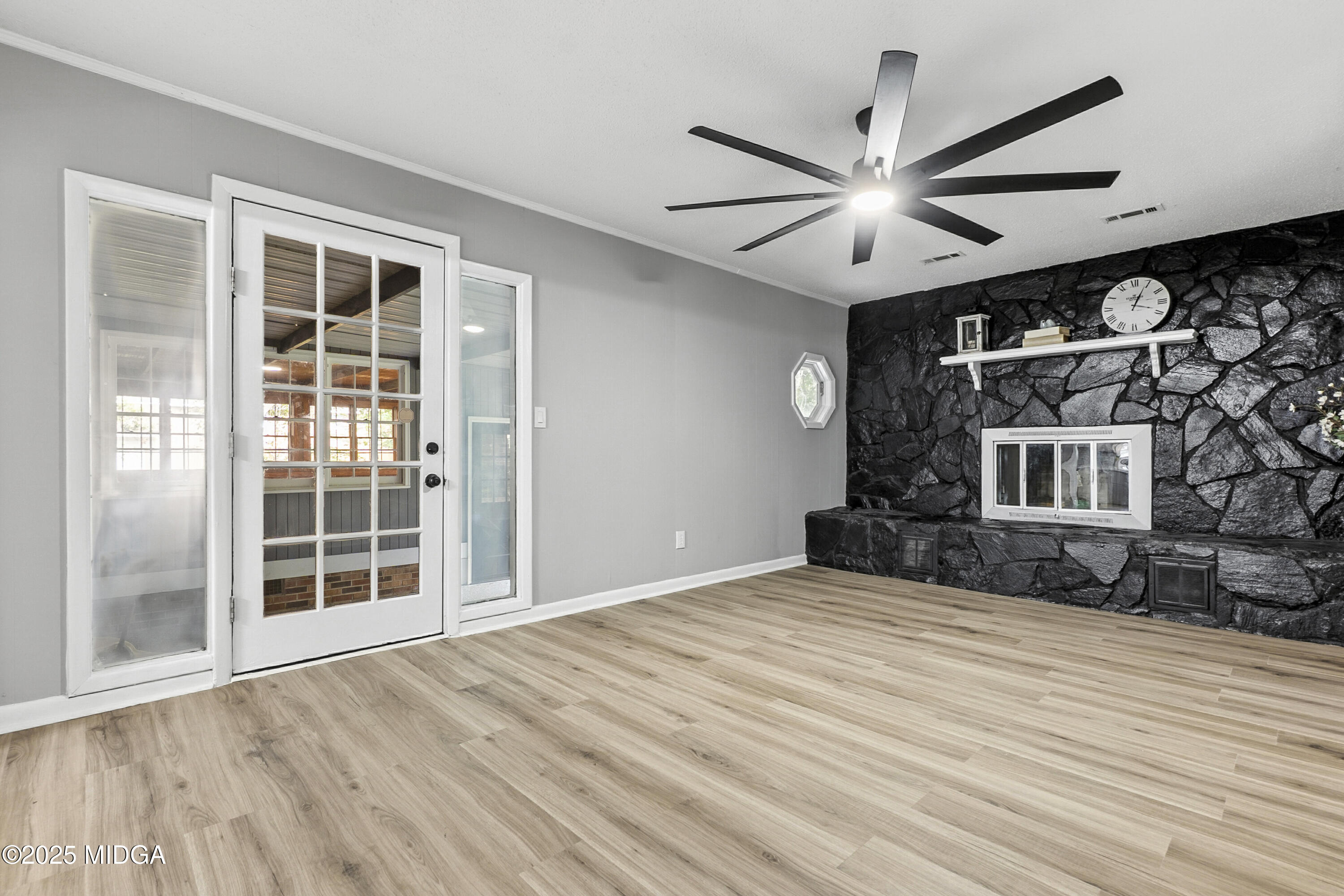 109 Scarborough Road Centerville, GA 31028 - Photo 18 of 52 a view of an empty room with a window and wooden floor