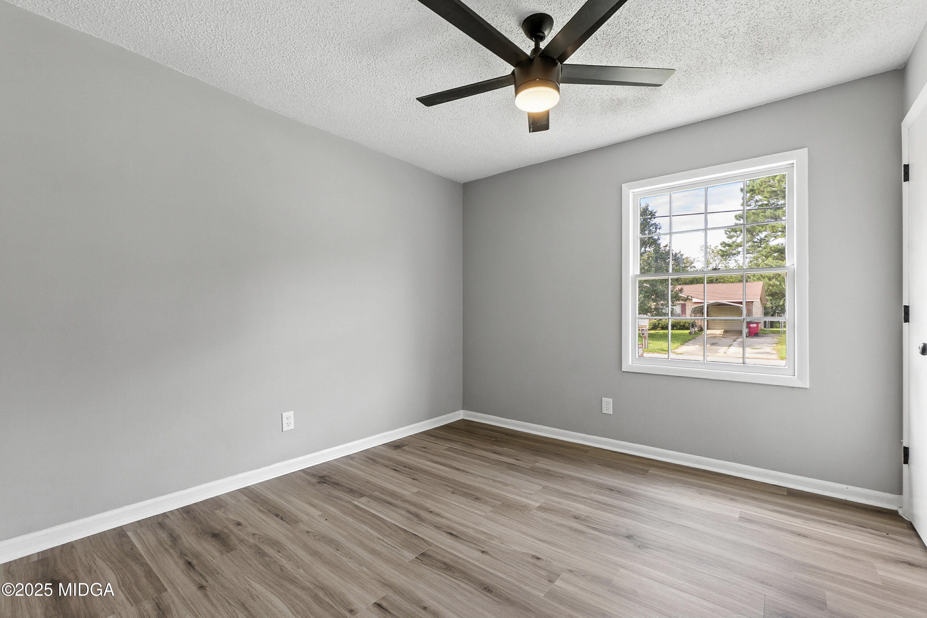 109 Scarborough Road Centerville, GA 31028 - Photo 23 of 52 an empty room with wooden floor and windows