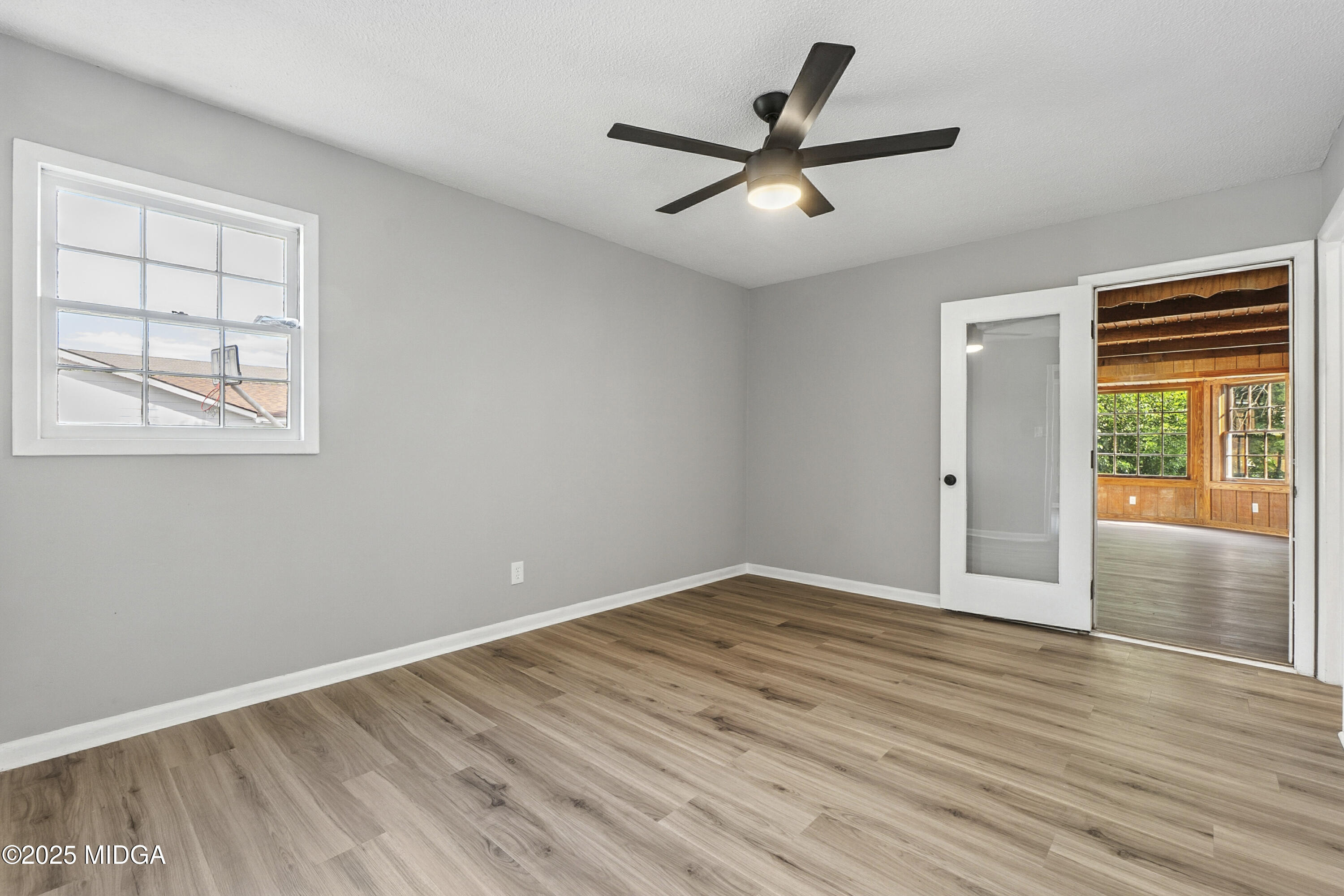 109 Scarborough Road Centerville, GA 31028 - Photo 29 of 52 wooden floor in an empty room with a window