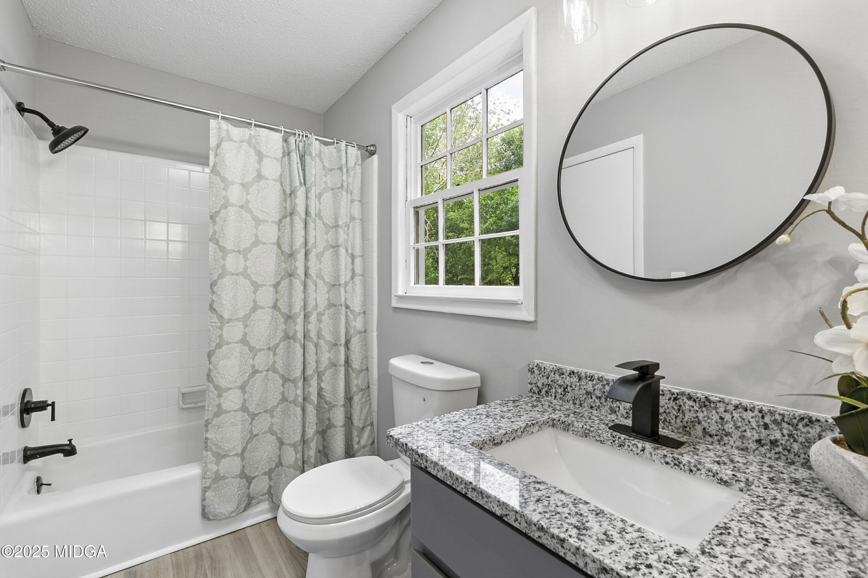 109 Scarborough Road Centerville, GA 31028 - Photo 40 of 52 a bathroom with a granite countertop sink a toilet and a mirror