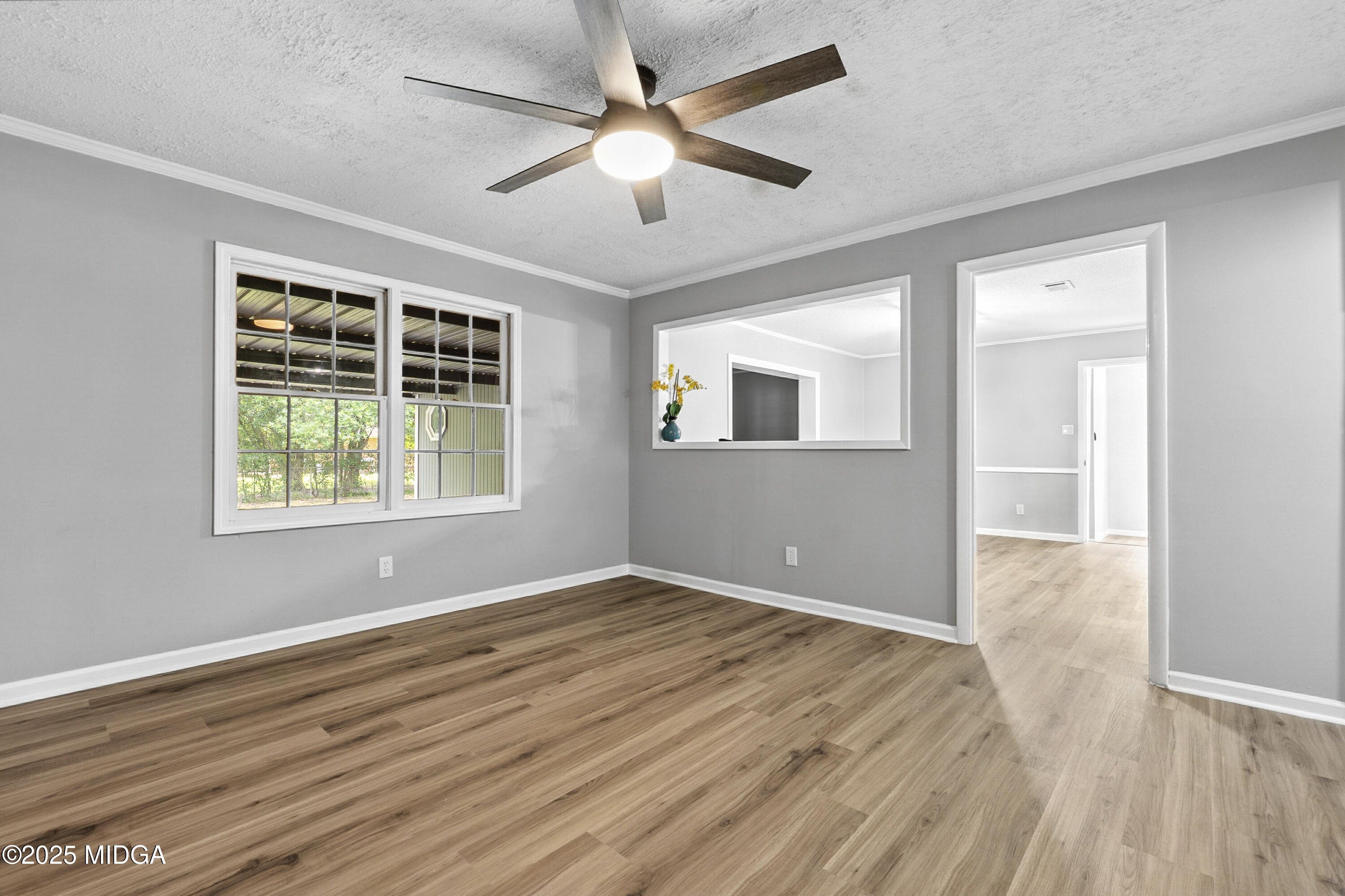 109 Scarborough Road Centerville, GA 31028 - Photo 6 of 52 a view of an empty room with wooden floor and a window