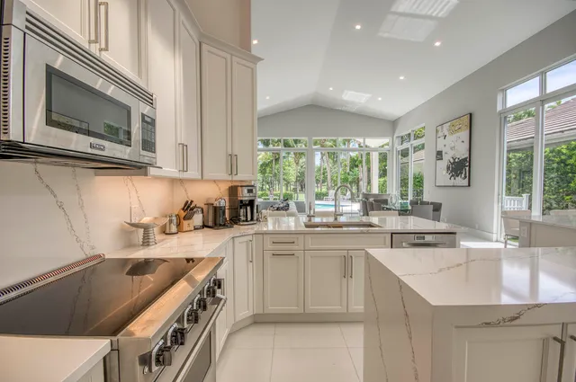 a kitchen with a sink stove and microwave