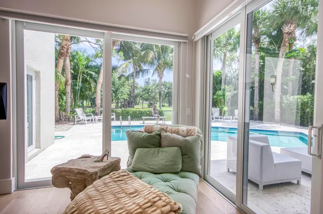 a bedroom with furniture and a large window