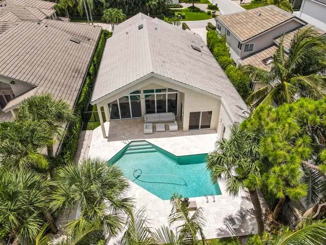 an aerial view of residential house with outdoor space and lake view in back