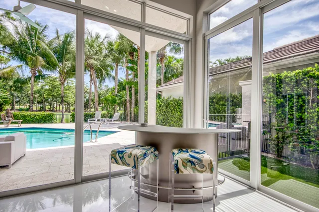 a view of a dining room with furniture wooden floor and garden view