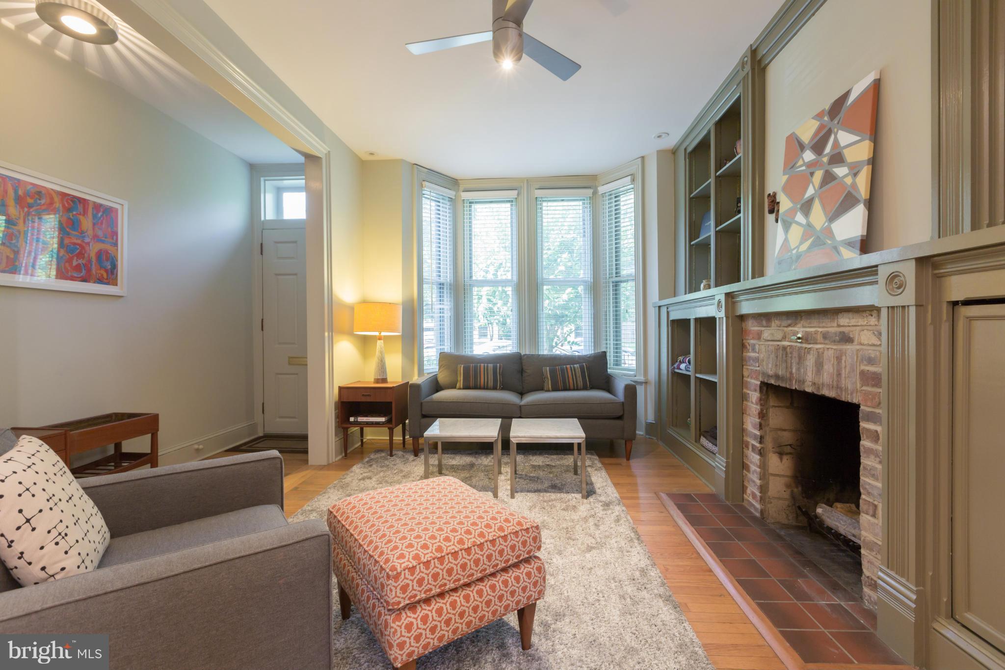 1450 T Street Northwest Washington, DC 20009 - Photo 3 of 14 a living room with furniture and a fireplace