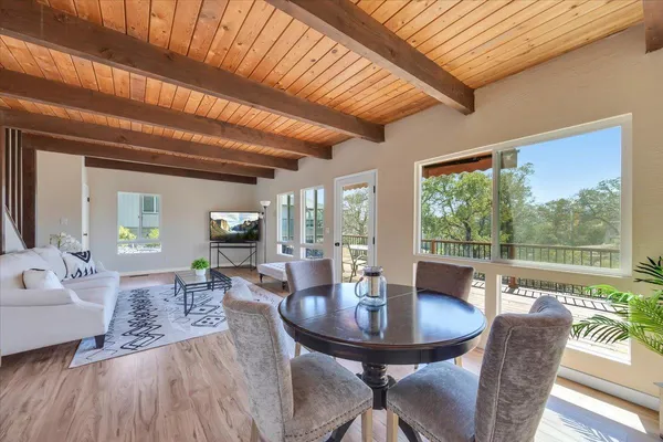 a view of a dining room with furniture window and wooden floor