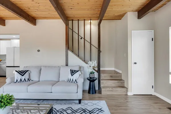 a living room with furniture and wooden floor