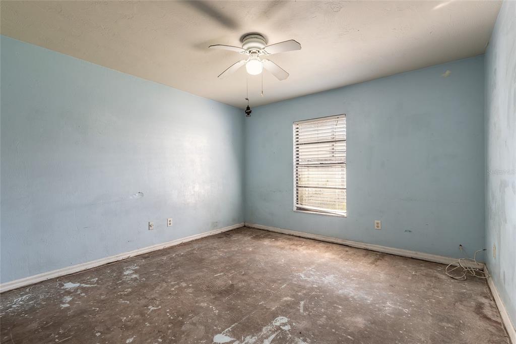 1678 Espanola Avenue Daytona Beach, FL 32117 - Photo 11 of 26 an empty room with windows and chandelier fan