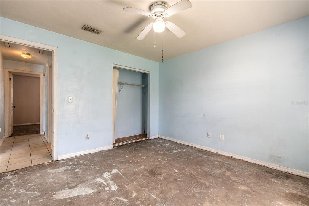 1678 Espanola Avenue Daytona Beach, FL 32117 - Photo 12 of 26 an empty room with a chandelier fan and windows