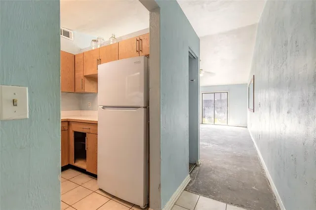 a view of a kitchen with a refrigerator a sink and dishwasher