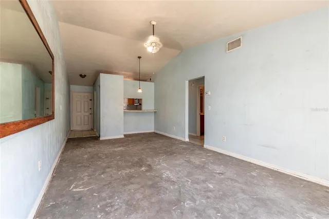 an empty room with a cabinet and mirrors