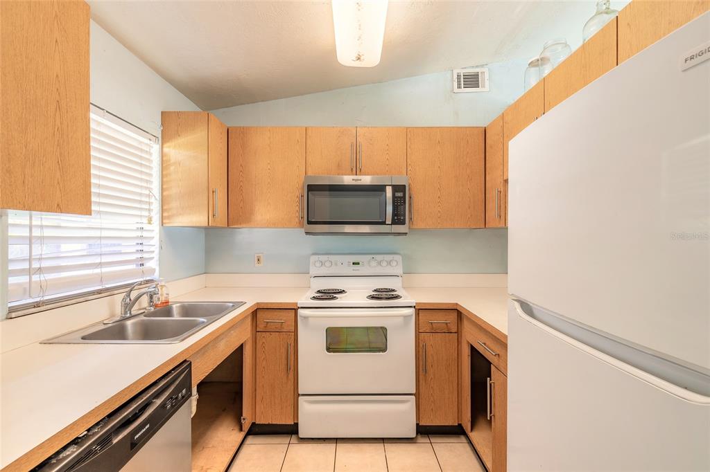 1678 Espanola Avenue Daytona Beach, FL 32117 - Photo 8 of 26 a kitchen with a stove microwave and sink