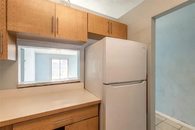 a white refrigerator freezer sitting in a kitchen