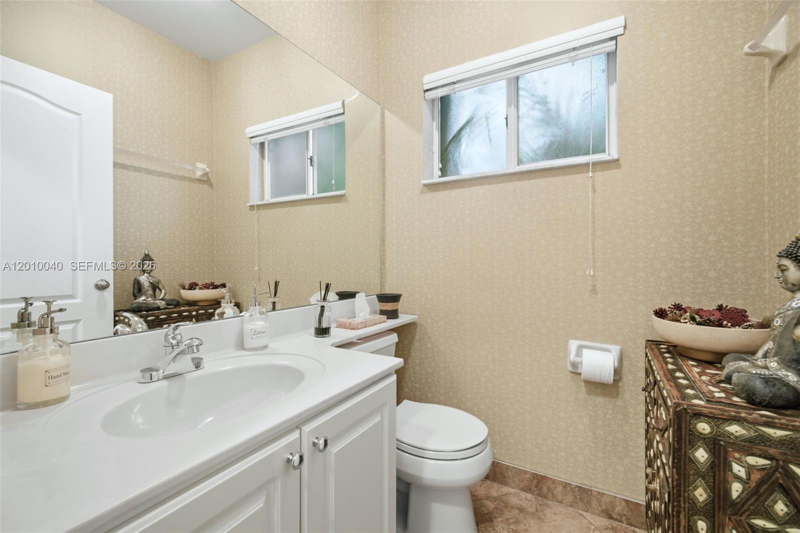 12978 Southwest 29th Court Miramar, FL 33027 - Photo 12 of 32 a bathroom with a sink mirror and toilet