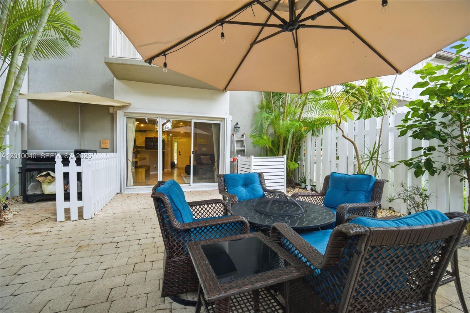 12978 Southwest 29th Court Miramar, FL 33027 - Photo 16 of 32 a view of a patio with table and chairs under an umbrella