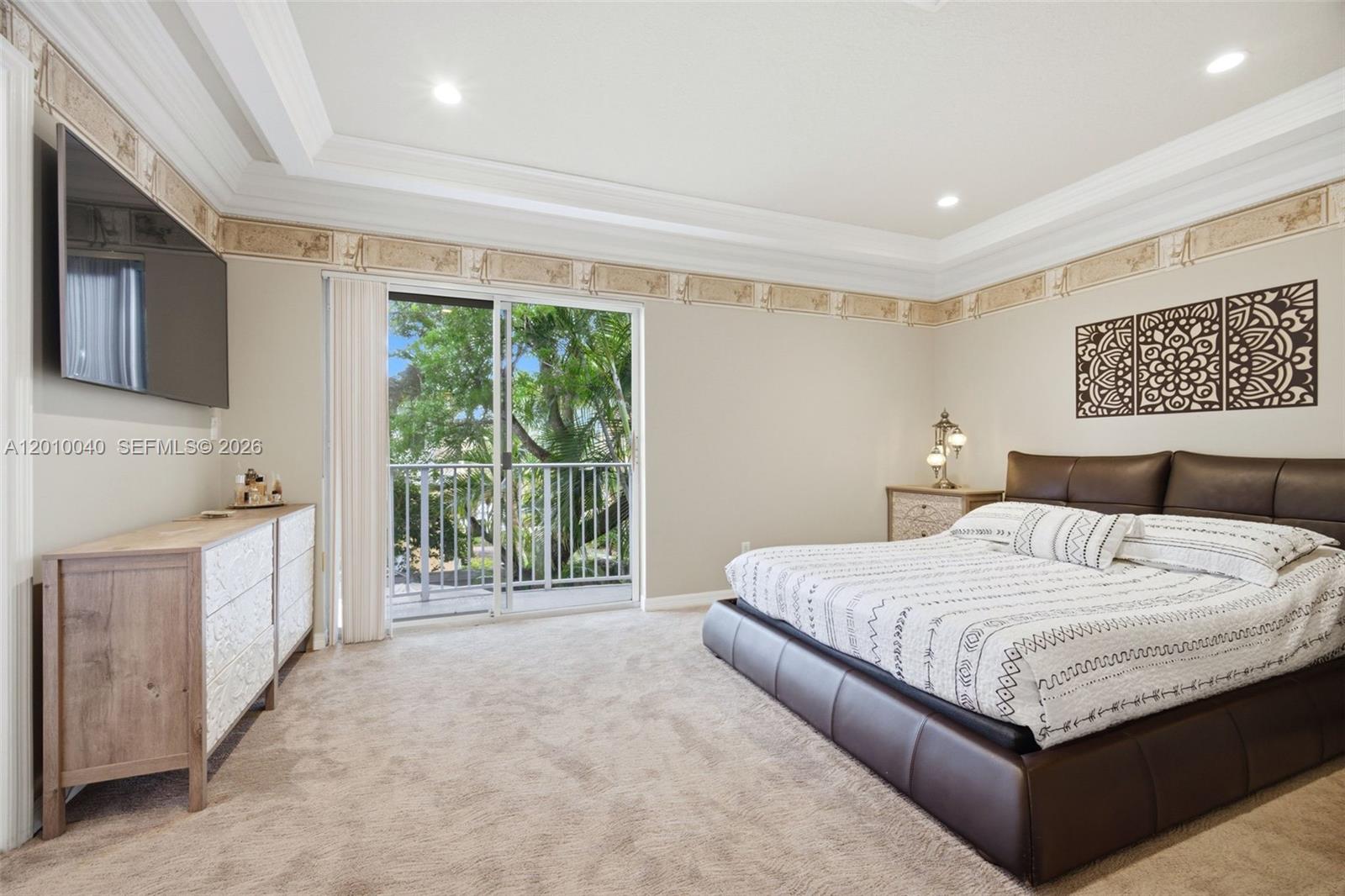 12978 Southwest 29th Court Miramar, FL 33027 - Photo 19 of 32 a spacious bedroom with a large bed and a flat screen tv